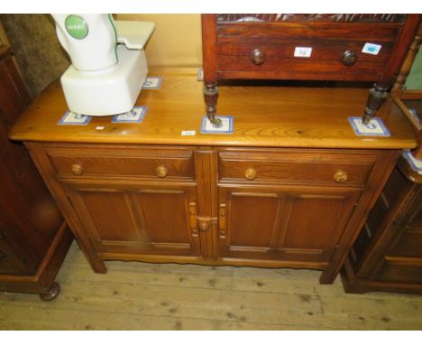 An Ercol medium elm sideboard with two drawers and two panelled doors 