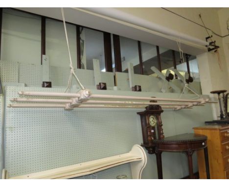 A vintage painted wooden hanging clothes rail 