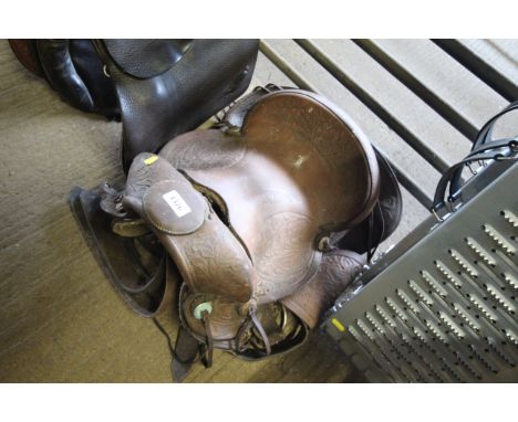 An ornate Western style horse riding saddle with handle