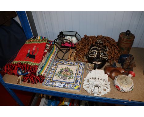 A collection of vintage world souvenirs including Chokwe mas, Portuguese hand painted set of nine tiles etc.