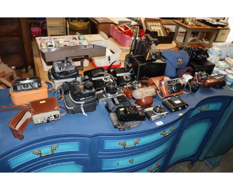 A quantity of various cameras to include Canon, Hellana, Olympus, Polaroid