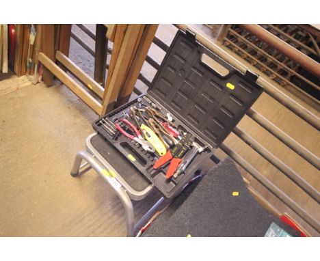 A plastic case of various hand tools (unassociated together with a caravan step)