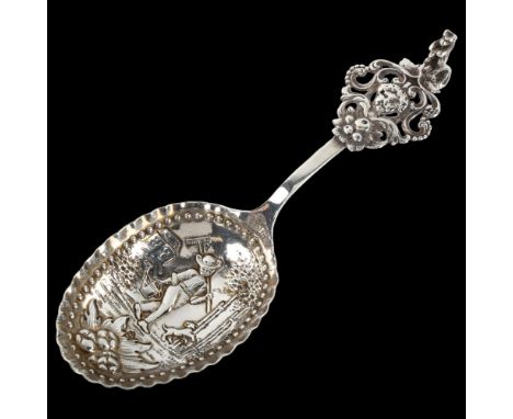 A large Dutch silver spoon, circa 1900, with relief embossed farmer bowl and standing bear handle, length 18cm, 1.8ozNo damag