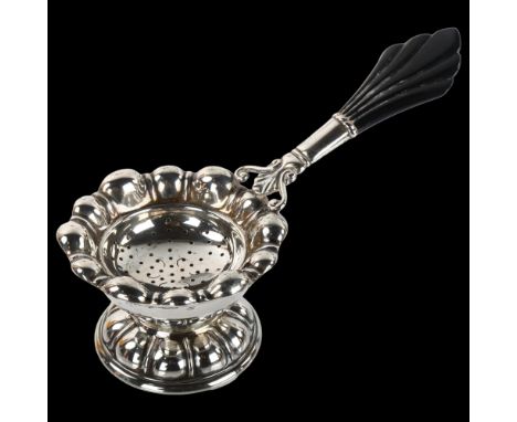 CARL M COHR - a Danish Art Deco silver and Bakelite tea strainer and stand, strainer length 15cm, 2.7oz grossNo damage or rep
