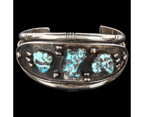 A heavy Native American Navajo turquoise cuff bracelet, unmarked silver settings, setting height 35.2mm, internal circumferen