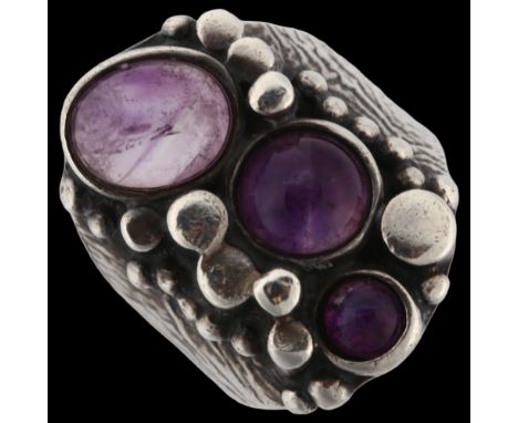 A Norwegian brutalist sterling silver and amethyst ring, set with oval and round cabochon amethyst, setting height 26.4mm, si