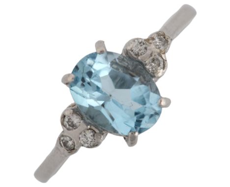 A late 20th century 18ct white gold aquamarine and diamond dress ring set with oval mixed-cut aqua and modern round brilliant