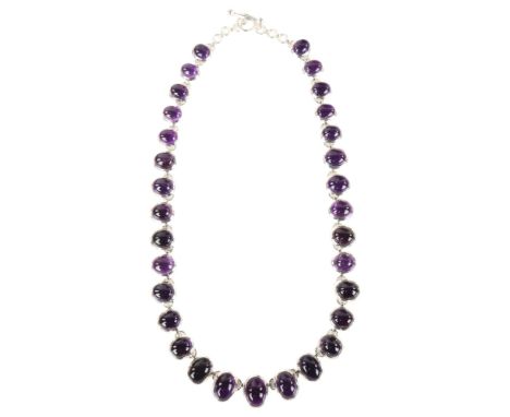 A large modern silver graduated amethyst fringe necklace, set with oval cabochon amethyst, necklace length 50cm, 82.9gNo dama