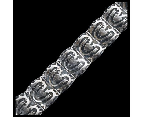 A Scandinavian sterling silver Viking Revival design panel bracelet, with mythological creatures, bracelet length 18cm, 49gNo