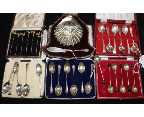 A cased silver butter dish and knife set, 3 sets of silver coffee spoons, a part set and 6 cocktail stirrers with cockerel fi