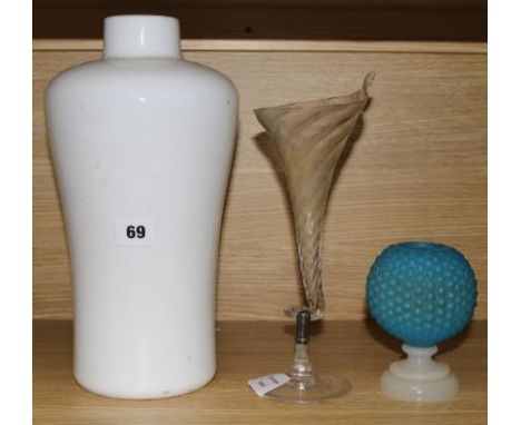 An opaque white glass lamp and two glass vases