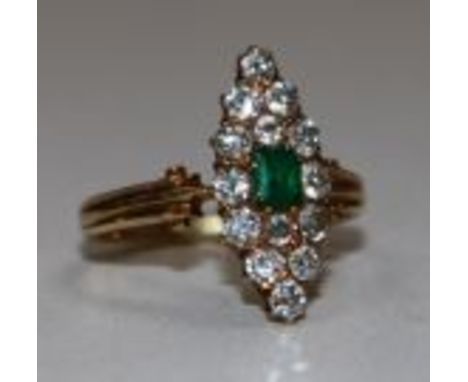 A gold, emerald and diamond cluster marquise shaped ring, size K.