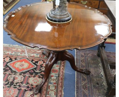 A George III mahogany circular topped supper table, on turned pillar and cabriole tripod base, the underside top, stamped wit