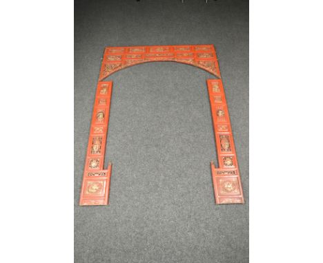 A late 19th Century Chinese red lacquered gilt decorated door or bed surround, pierced panels and carved decoration of warrio