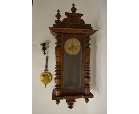 A Vienna wall clocks, in a stained beech case, with lacquered brass and pressed metal Art Nouveau face surmounted by stepped 