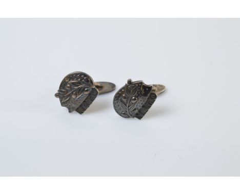 A pair of Georg Jensen silver cufflinks, with Hedghog, leaf and berry design above the inscription "NATO". Front- 2cm x 2cm. 