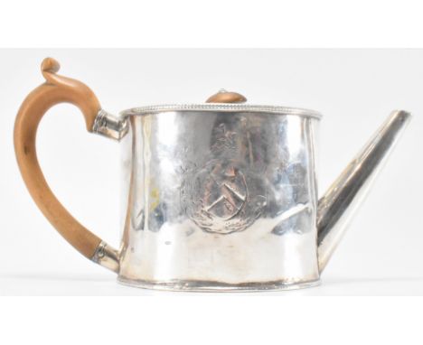 A hallmarked silver George III William Vincent teapot. The teapot of drum form with a flush-hinged lid to the top with carved