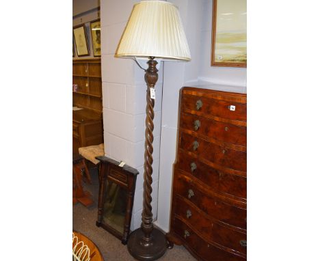 An oak standard lamp with spiral twist column.