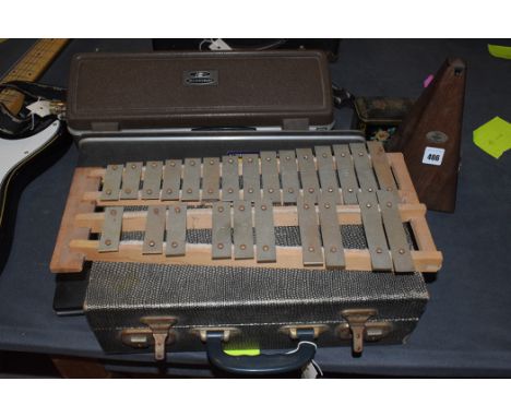 A clarinet by Console, Selmer, London, cased; an Aristocrat flute by Buescher; another flute, made in Japan; a metronome; and