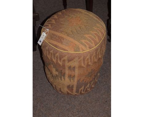 A 20th Century pouffe upholstered in kilim material.