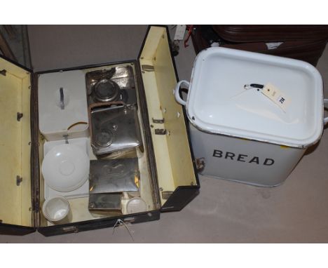 A Banda Ware picnic set, cased; and an enamel bread bin.