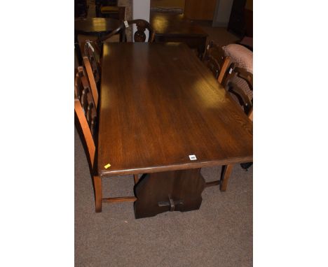 A 20th Century stained oak refectory style dining table, 151cms long; four oak ladder back dining chairs, the drop-in seats u