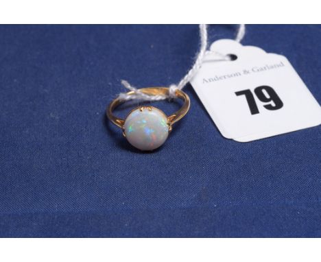 An opal ring, on yellow metal shank, ring size L.