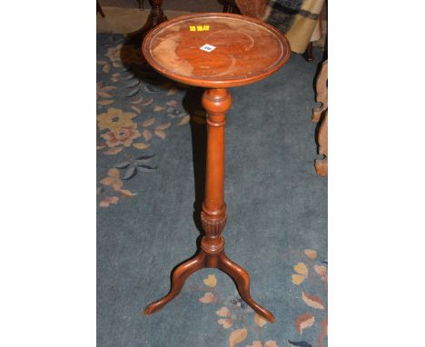 A reproduction mahogany jardiniere stand, raised on tripod legs.
