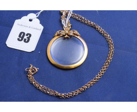 A yellow metal and seed pearl photo-pendant on a 9ct. yellow gold fine link chain.