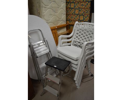 A modern white plastic garden table, 135.5cms long; and four white plastic stackable garden chairs; and two small aluminium s