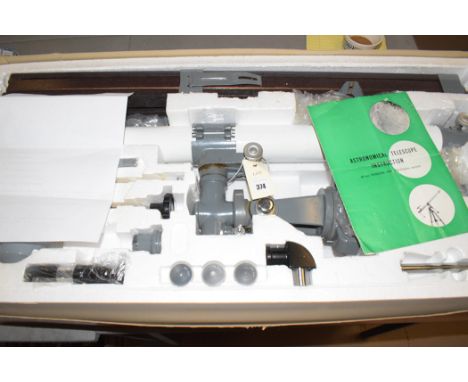 An astronomical telescope, 60mm with equatorial mount, boxed, with instruction manual.