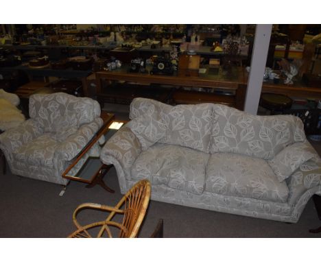 A three-piece sitting room suite, possibly by Wade, comprising: a three-seater sofa and a pair of armchairs, upholstered in g