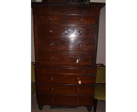 A Victorian mahogany chest on chest, turned wooden handles centred by mother-of-pearl detailing, raised on turned feet, 119cm