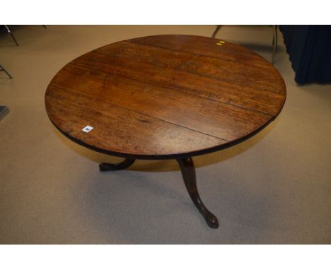 A 19th Century circular oak tripod occasional table, 89.5cms diameter (cut down).