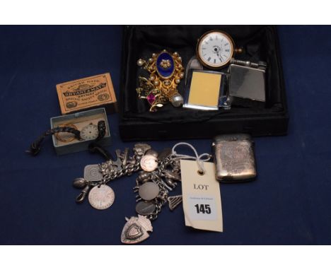 A white metal charm bracelet, stamped 'Silver 830'; a George V silver vesta case, by William Hair Haseler, Birmingham 1919; a