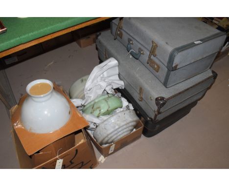 Three suitcases containing curtains and other fabrics; together with miscellaneous lamp shades.