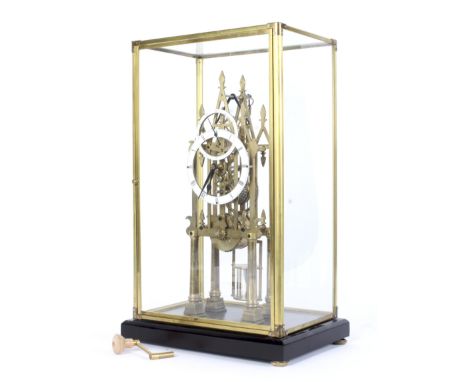A mid-20th century contemporary Gothic skeleton clock. The fusee movement with 13.5cm dial showing the minutes and hours unde