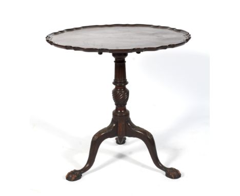An early 20th century circular piecrust tilt top tripod table. Raised on a turned reeded and gadroon decorated column to outs