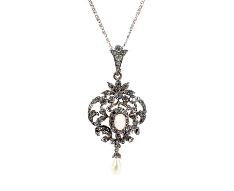 A late Victorian/Edwardian opal and paste pendant. Centred with an oval cabochon white opal, rub-over set in rose gold within