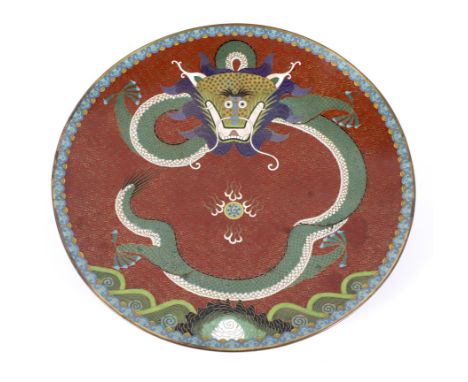 An early 20th century Chinese cloisonne enamel five-claw dragon charger. The scrolling dragon chasing a flaming pearl, reserv