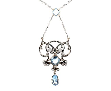 A late Victorian aquamarine and diamond double-scroll pendant necklace. With a central round mixed-cut aquamarine approx. 1.4