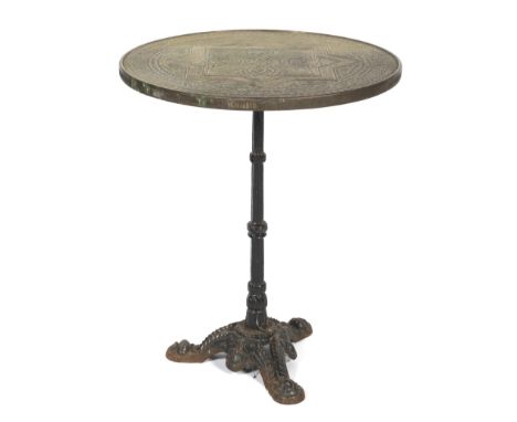 An Indian brass circular table top. Raised on a cast iron reeded column to a pierced tripod base, Dia 59.5cm x H73cm.