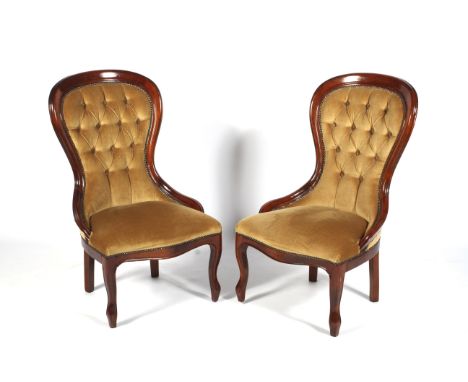 A pair of contemporary mahogany framed spoon button back nursing chairs. Upholstered in gold velvet with overstuffed seats, r