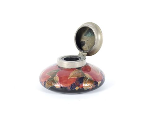 An early 20th century Moorcroft pewter-mounted pomegranate pattern inkwell. Impressed and painted marks, of compressed globul