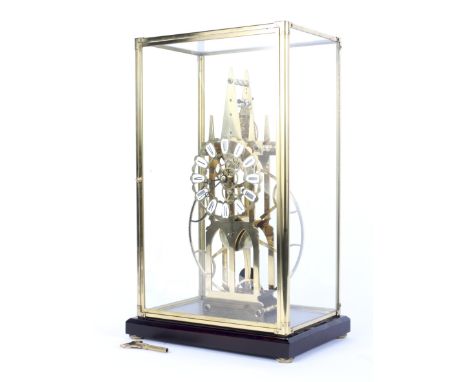 A large contemporary Great Wheel brass skeleton clock. The brass chapter ring with white enamel numeral plaques enclosing a s