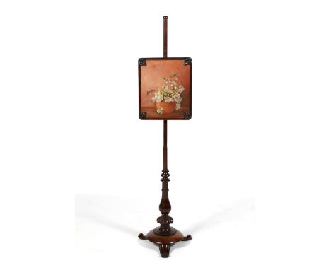 A Victorian rosewood painted pole screen depicting a bowl of flowers. Raised on a turned column to a baluster, floral carved 
