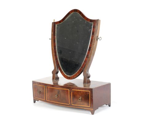 A Regency mahogany shield-shaped dressing table mirror. Inlaid with boxwood stringing, on bow fronted base inset with three d