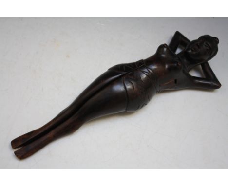 A NOVELTY TREEN NUTCRACKER IN THE FORM OF A FEMALE WITH OPENING LEG, H 33 cm