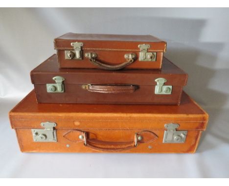 A VINTAGE LEATHER SMALL SUITCASE BY 'VICTOR LUGGAGE', W 60.5 cm, D 16.5 cm, H 35.5 cm, together with two smaller faux leather
