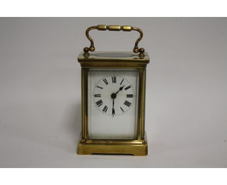 A SMALL BRASS CASED DUVERDREY &amp; BLOQUEL CARRIAGE CLOCK, the enamel dial with Roman numerals, the movement with lion backs